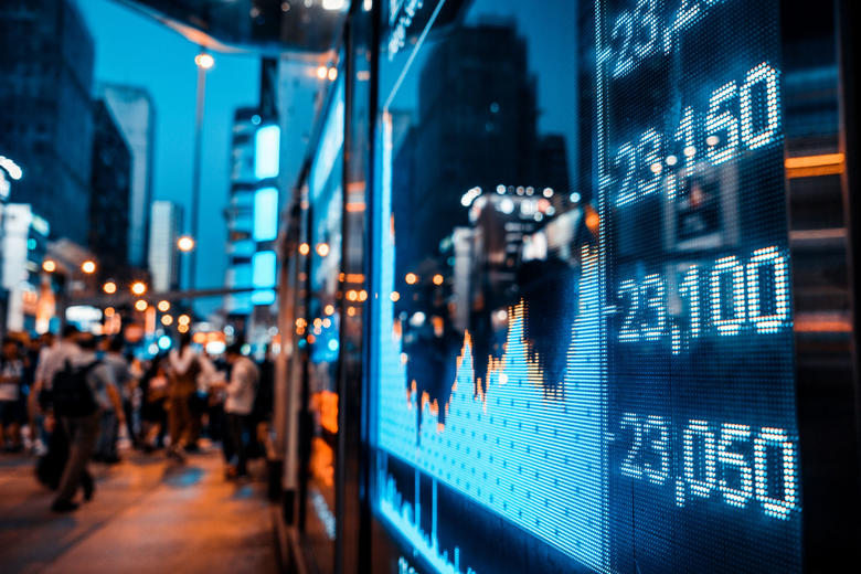 stock exchange screen in busy city street