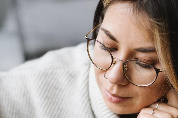 Thoughtful young woman preparing for exam at home