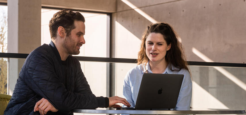 lecturer and student chatting at manor road building