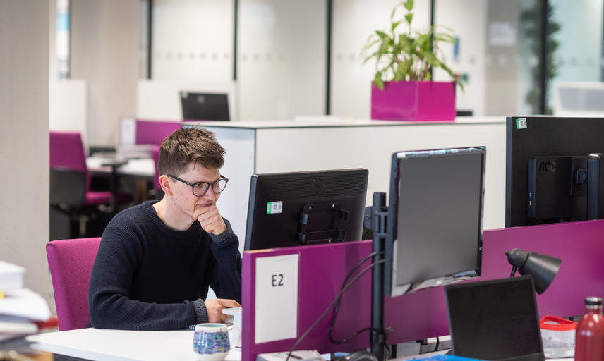 DPhil student working at a computer