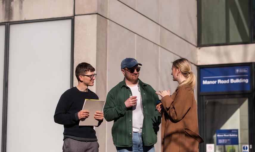 Three students talking outside