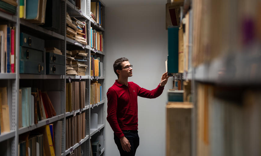 an academic looks at bookshelves